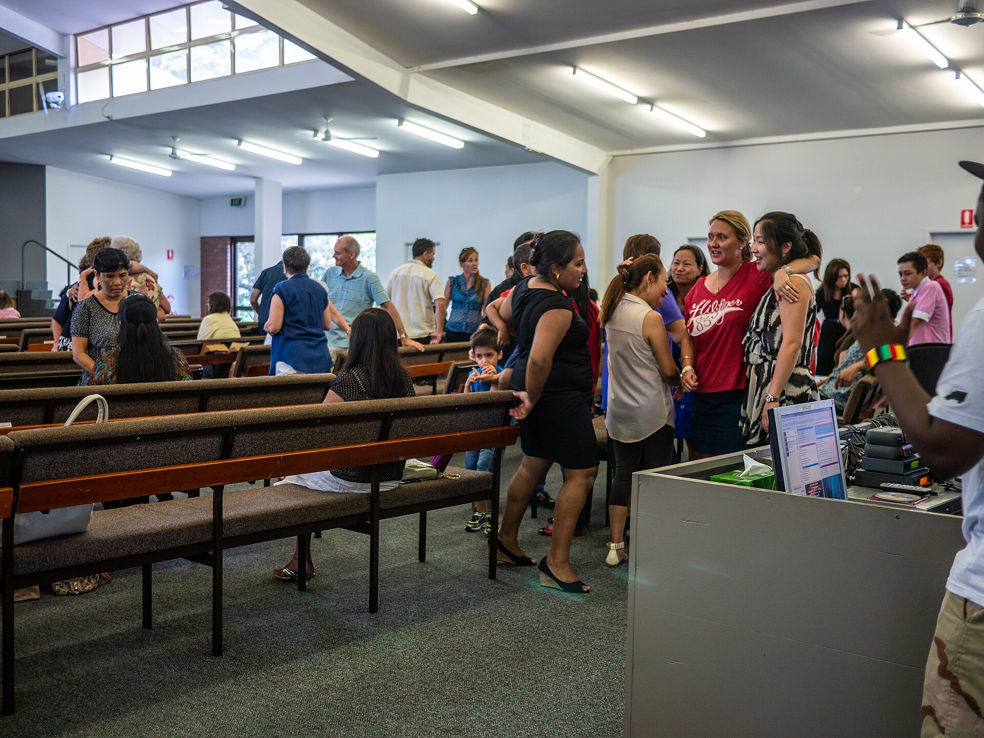 Church volunteers welcoming and greeting attendees before a Sunday service