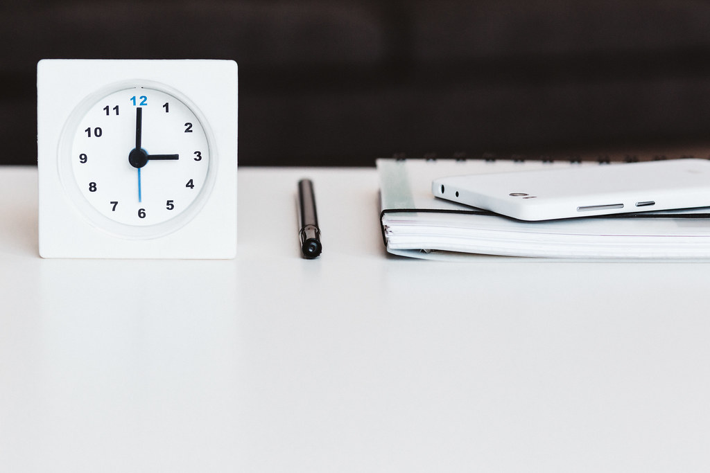 Planning materials on a desk with a calendar and smartphone for Sunday service coordination