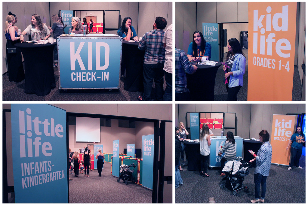 Children's ministry check-in area with volunteers helping families register before a program begins